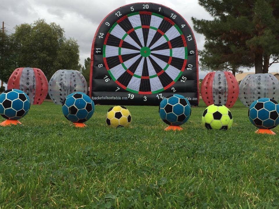 Giant soccer dartboard with soccer balls ready to kick