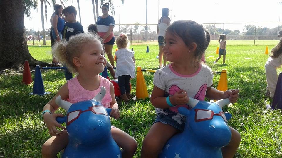 Two toddlers bouncing on animal hoppers