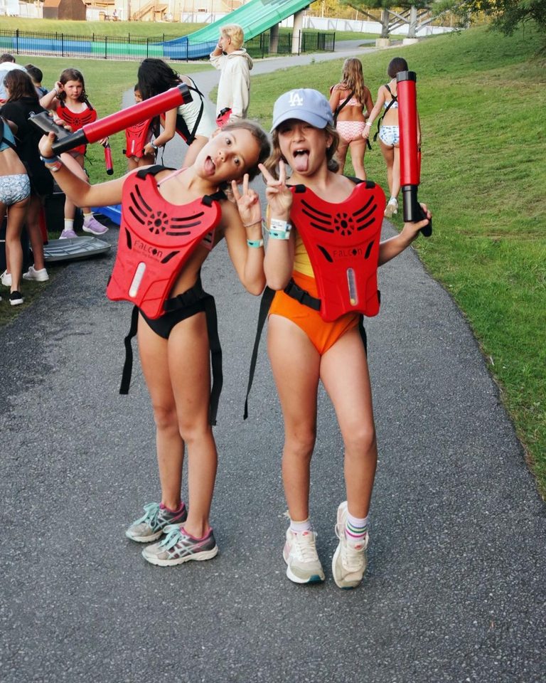 Two girls in Crazy Water Tag vests holding water blasters