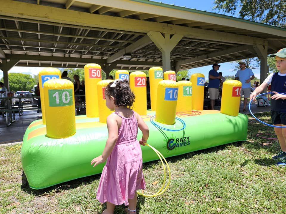 Girl playing the inflatable ring toss game