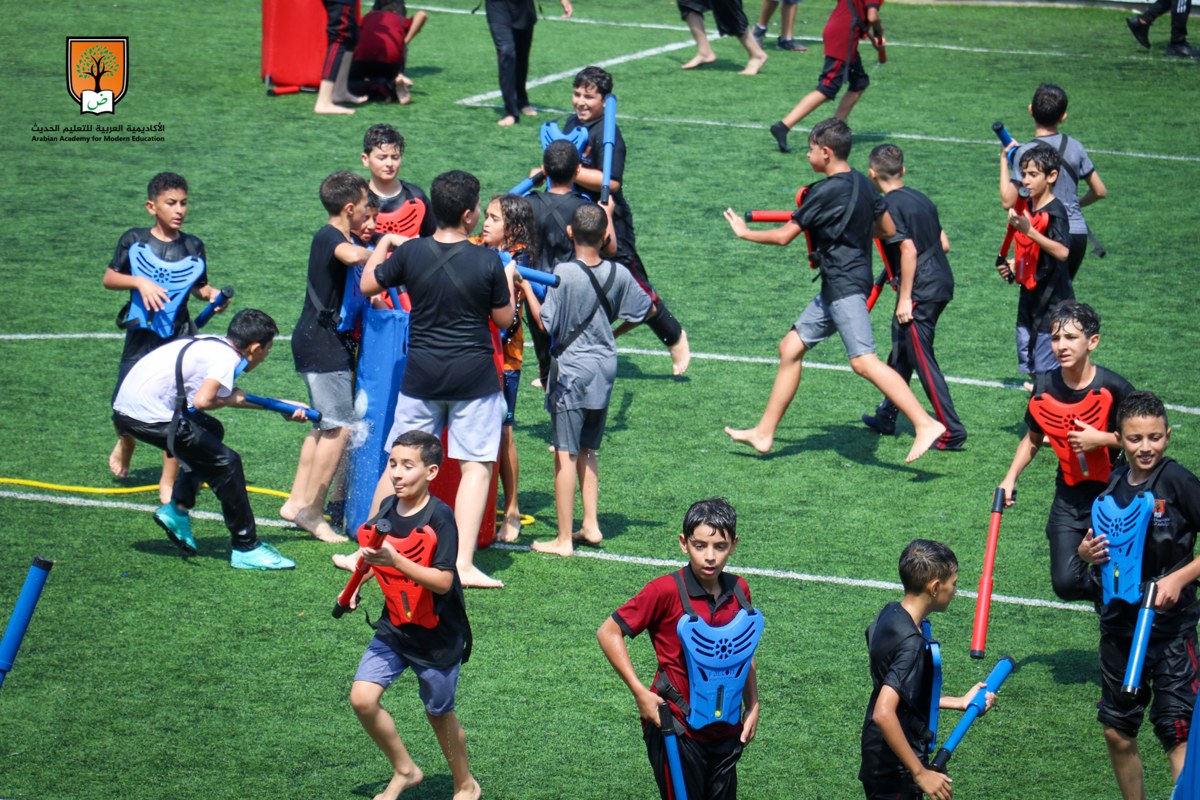 Kids in Crazy Water Tag vests playing a water game on a grass field at a South Florida party
