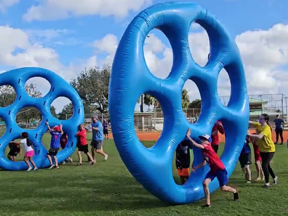 Kids racing our giant inflatable wheels at a park event