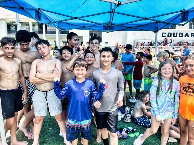 Camp crew smiles at a Crazy Games event