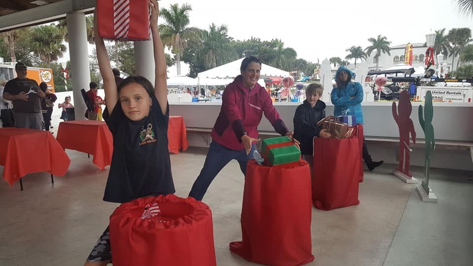 Kids playing Crazy Games holiday games at a real Palm Beach County event