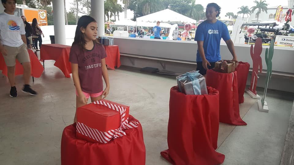 Kids playing Crazy Games holiday games at a real Palm Beach County event