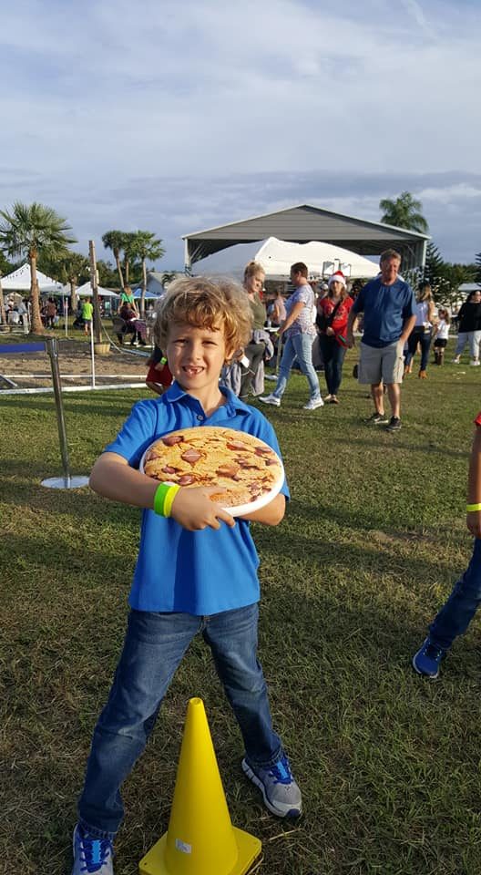 Kids playing Crazy Games holiday games at a real Palm Beach County event