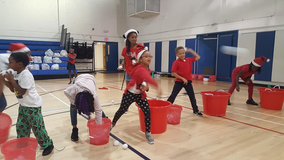 Kids throwing soft snowballs in a Crazy Games Snowball Fight at a school holiday party