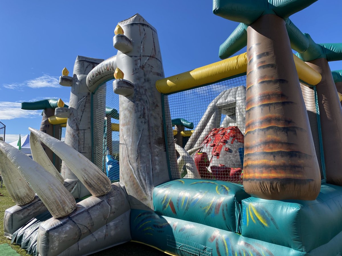 Crazy Games FL Jurassic Park Adventure obstacle course with rock wall set up on a sunny lawn in Palm Beach County