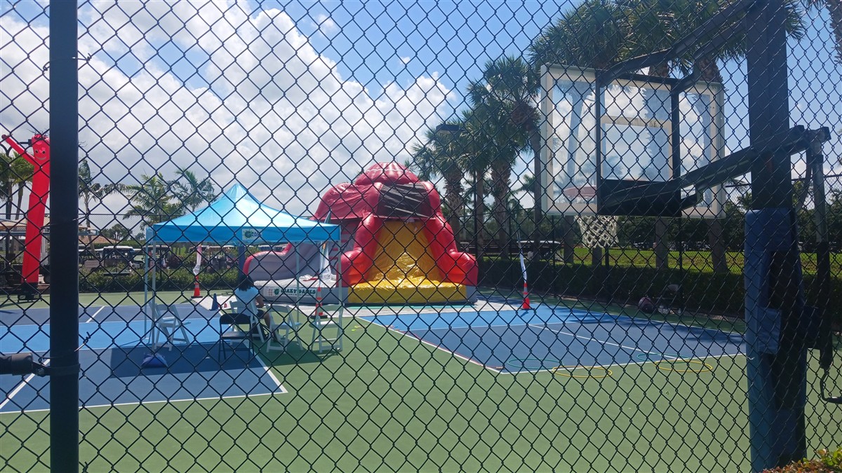 Red inflatable and canopy set up on a courtyard for a Palm Beach County event