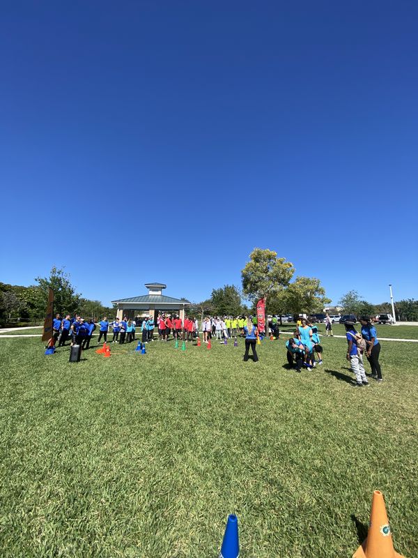 Crazy Games FL party games on an open park field with a covered pavilion in the background