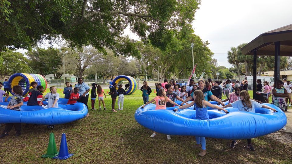 Kids racing through the Honeycombs inflatable rings