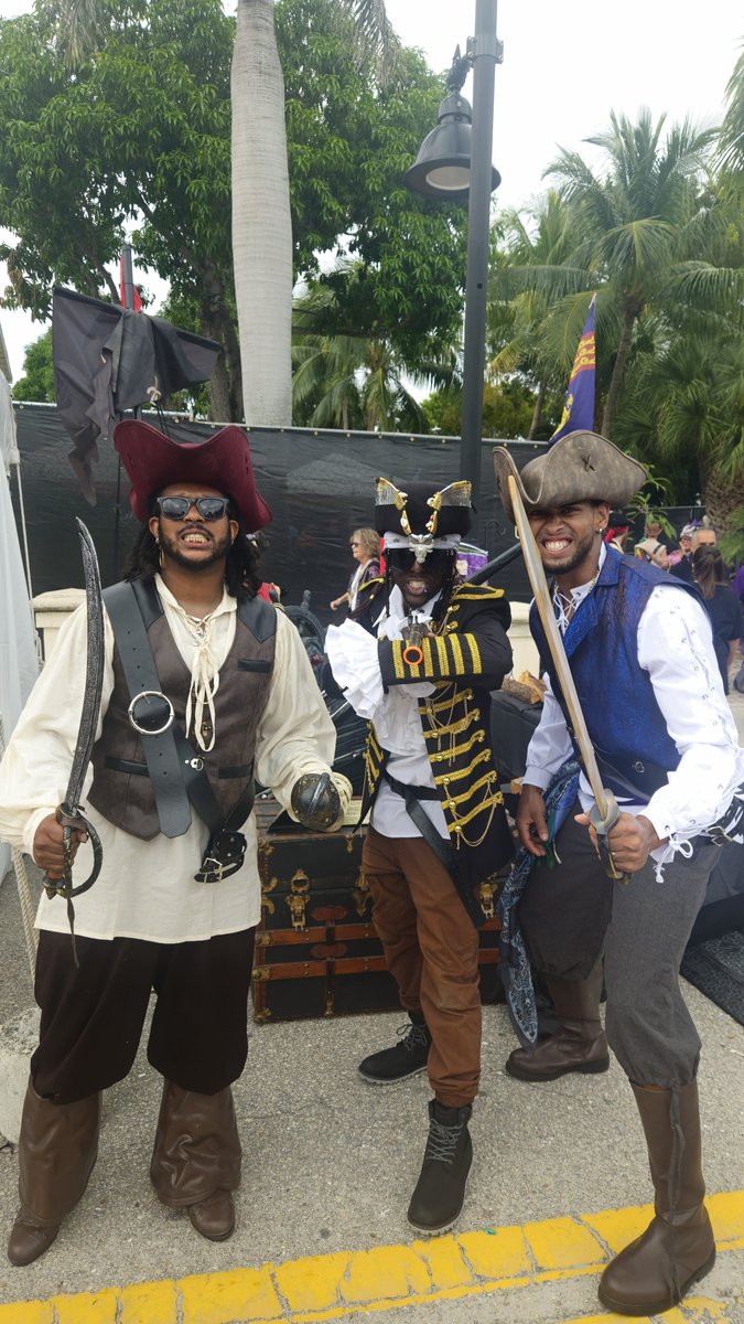 Three Crazy Games pirate actors in full costume standing together at an outdoor treasure hunt event