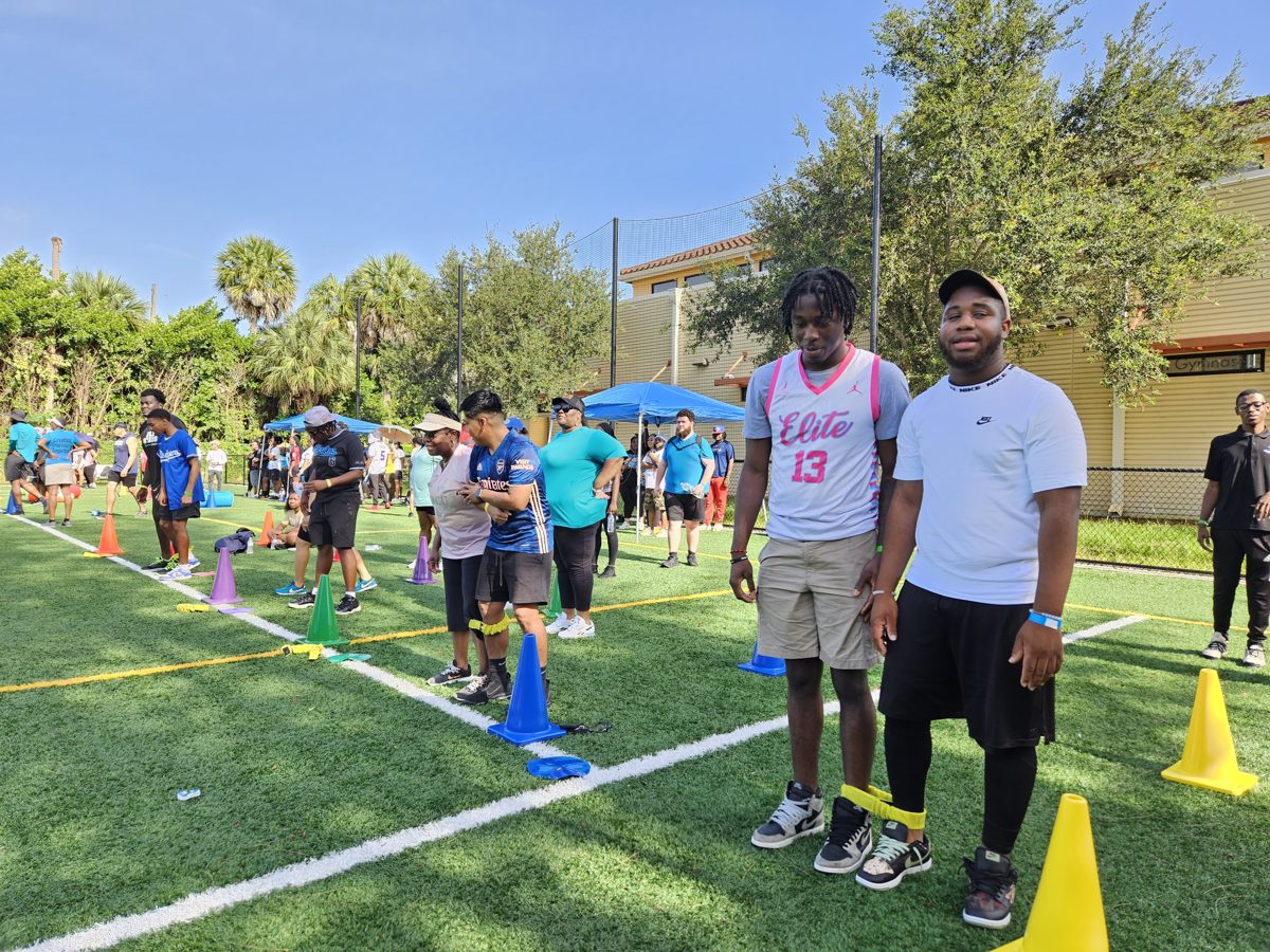 Teens and adults lining up for a three-legged race at a Crazy Games field day in Palm Beach County