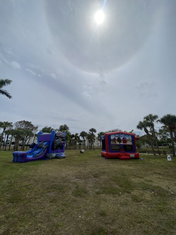 Two Crazy Games FL bounce houses set up and ready on an open park field